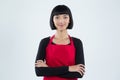 Smiling waitress standing with arms crossed against white background Royalty Free Stock Photo