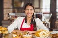 Smiling waitress standing over pastries Royalty Free Stock Photo