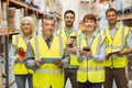 Smiling warehouse team looking at camera