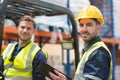 Smiling warehouse worker and forklift driver Royalty Free Stock Photo