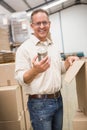 Smiling warehouse worker holding metal tin can Royalty Free Stock Photo