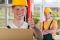 Smiling warehouseman showing thumbs up sign Royalty Free Stock Photo