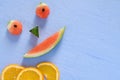 Smiling Water Melon and Orange Slices on Blue Background