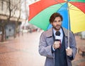 And it looks like rain today folks. A smiling weatherman reporting from an urban area. Royalty Free Stock Photo