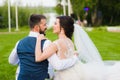 Smiling wedding couple from the back outdoors Royalty Free Stock Photo