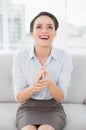 Smiling well dressed woman applauding while looking up Royalty Free Stock Photo