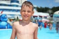 Smiling wet boy near pool in aquapark Royalty Free Stock Photo