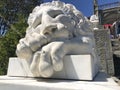 A smiling white marble lion sculpture