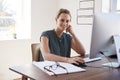 Smiling white woman working in an office looking to camera Royalty Free Stock Photo