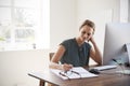 Smiling white woman working in an office making notes