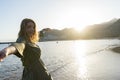 Smiling wife holding husband hand while follow on the beach with summer dress. Happy couple walking with affection and vitality. Royalty Free Stock Photo