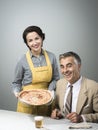 Smiling wife serving dinner Royalty Free Stock Photo