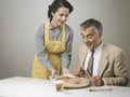 Smiling wife serving dinner Royalty Free Stock Photo