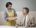 Smiling wife serving dinner Royalty Free Stock Photo