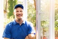 Window installer in blue uniform standing in the room