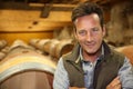 Smiling winemaker in wine cellar