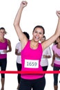 Smiling winner athlete crossing finish line with arms raised Royalty Free Stock Photo