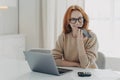 Smiling woman accountant financier uses voice recognition system on smartphone, records audio message Royalty Free Stock Photo