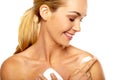 Smiling woman applying body cream Royalty Free Stock Photo