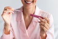 Smiling woman applying lip gloss holding tube, closeup Royalty Free Stock Photo