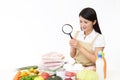 Asian housewife with a magnifying glass Royalty Free Stock Photo