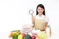 Asian housewife with a magnifying glass Royalty Free Stock Photo