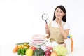 Asian housewife with a magnifying glass Royalty Free Stock Photo