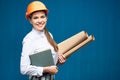 Smiling woman architect holding book and paper plan