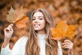 Smiling woman with autumn leaves. Girl with orange leaves. Season and autumn holiday. Beauty and fashion. Smiling model Royalty Free Stock Photo