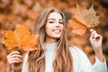 Smiling woman with autumn leaves. Girl with orange leaves. Season and autumn holiday. Beauty and fashion. Smiling model