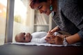 Smiling woman with baby on her hands, family happiness, love an