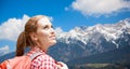 Smiling woman with backpack over alps mountains Royalty Free Stock Photo
