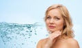 Smiling woman with bare shoulders touching face Royalty Free Stock Photo