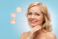 Smiling woman with bare shoulders touching face Royalty Free Stock Photo