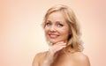 Smiling woman with bare shoulders touching face Royalty Free Stock Photo