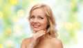 Smiling woman with bare shoulders touching face Royalty Free Stock Photo