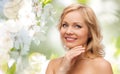 Smiling woman with bare shoulders touching face Royalty Free Stock Photo
