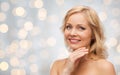 Smiling woman with bare shoulders touching face Royalty Free Stock Photo