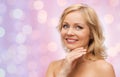 Smiling woman with bare shoulders touching face Royalty Free Stock Photo