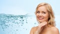 Smiling woman with bare shoulders touching face Royalty Free Stock Photo