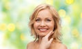 Smiling woman with bare shoulders touching face Royalty Free Stock Photo