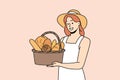 Smiling woman with basket of fresh bread