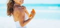 Smiling woman on beach applying sun block creme Royalty Free Stock Photo