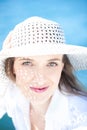 Smiling Woman On The Beach Wearing White Hat