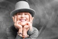 Smiling woman. Beautifu youngl woman wearing gray hat and in a gray sweatshirt. Young woman with beautiful smile happy and excited Royalty Free Stock Photo