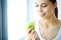 Smiling Woman With Beautiful Smile, White Teeth Holding Apple. H Royalty Free Stock Photo