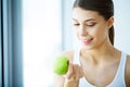 Smiling Woman With Beautiful Smile, White Teeth Holding Apple. H Royalty Free Stock Photo