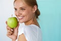 Smiling Woman With Beautiful Smile, White Teeth Holding Apple Royalty Free Stock Photo