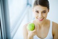 Smiling Woman With Beautiful Smile, White Teeth Holding Apple. H Royalty Free Stock Photo