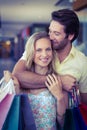 Smiling woman being kissed on forehead by her boyfriend